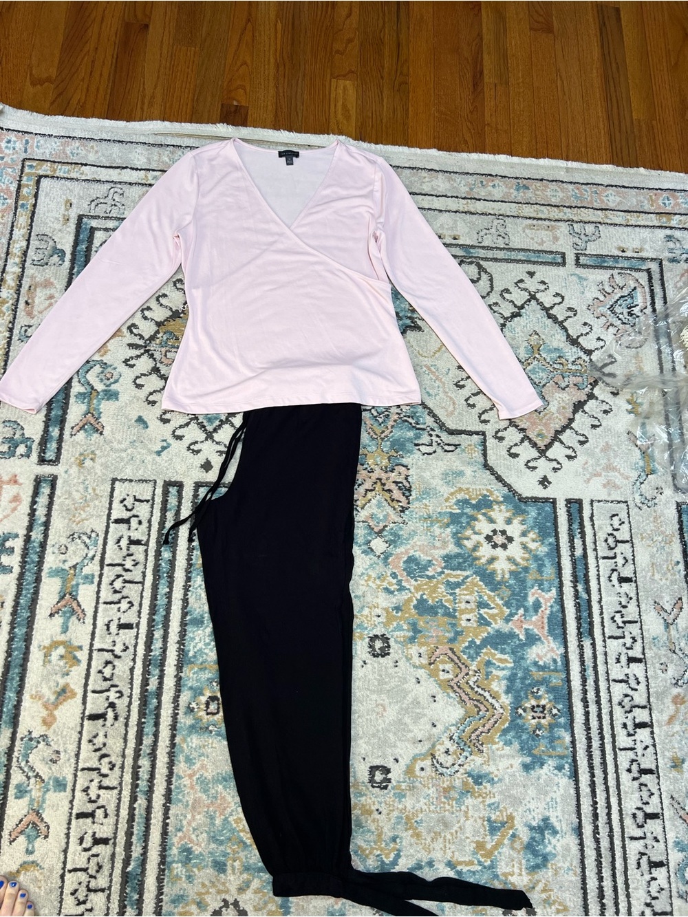 Women's Pink Long-Sleeve Wrap Top and Black Pants.